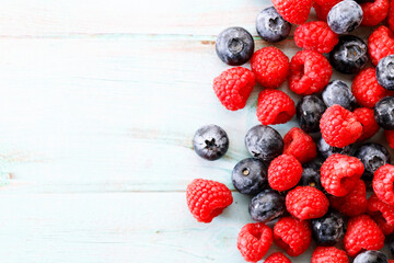 Wall Mural - Blueberries and raspberries on wooden table