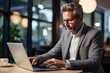 © Pakhnyushchyy - Creative male designer working on his laptop in an office. Business man working at the office working.