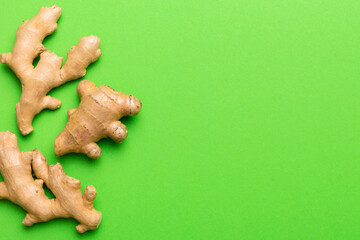 Wall Mural - Finely dry Ginger powder in bowl with green leaves isolated on colored background. top view flat lay