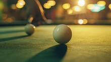 A Close Up Of The White Cue Ball On A Snooker Table During Play And A Hand With The Snooker Cue Stick About To Take A Shot