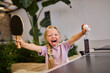 © Westend61 - Carefree girl holding table tennis racket and ball at villa