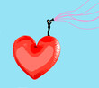© Westend61 - Woman speaking through megaphone from top of oversized heart shaped balloon