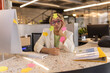 © Westend61 - Overworked businesswoman with arrow sticky notes all over her sitting at office