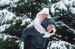 © Westend61 - Happy man piggybacking woman in front of snowcapped trees