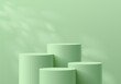 © Riseness - 3D background with set of realistic green cylinder product podium and natural leaf light scene. Abstract composition in minimal design. Platforms mockup product display presentation. Stage showcase.