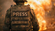 War reporter concept image with back of a reporter with written press in front of explosion and fire