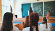 © Довидович Михаил - Girl students raise their hands in math class.