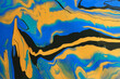 art photography of abstract marbleized effect background with blue, black and yellow creative colors. Beautiful paint.