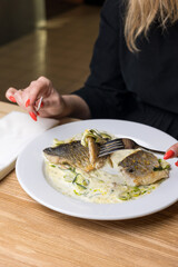 Wall Mural - Baked fish with zucchini and dill on a white plate