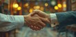 © Raptecstudio - Two men in a library gesture, sharing a handshake with electric blue sleeves