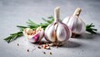 Garlic. Garlic bulbs. Fresh garlic with rosemary and pepper on white concrete board
