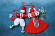 Red and white symbol of the holiday March 1 Martenitsa, figures of a boy and a girl with bouquet of snowdrop flowers on a blue background. Postcard for Martisor, Baba Marta
