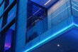 close-up photo highlighting the seamless integration of glass and steel in the architecture of a modern business office building, with blue accent lighting adding a touch of sophis