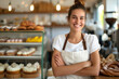 © Patcharaphon - Portrait of happy female in apron standing with fresh bake bread in her homemade bakery shop