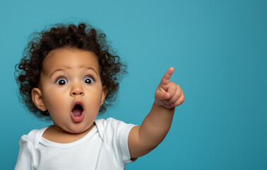 surprised baby pointing at background copy space