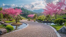 A Picturesque Japanese-style Garden Featuring A Pebbled Path Lined By Pink Cherry Blossoms, Manicured Greenery, And A Serene Atmosphere.