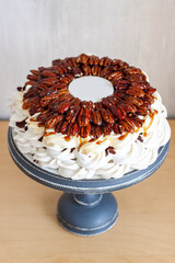 Wall Mural - Delicious Pavlova cake with pecans, chocolate sauce, maple syrup and fondant plate for text