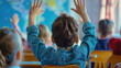© Santy Hong - Elementary age student boy raised hands up in class. Volunteering and participating classroom concept.