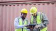 © TeTe Song - Two professional dock worker or engineering people discussing inventory lists with their supervisor while record data online with digital connection tablet at Container cargo, Import and Export