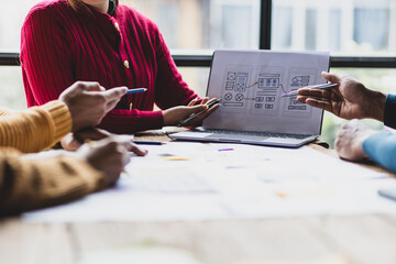 UX, UI designers collaborate to design user interfaces for smartphone apps based on user experience. Colleagues meeting, program designers brainstorm to discuss designing mobile applications.