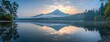 Majestic Peak Reflections: Tranquil Dawn Glow Over Serene Mountain Waters