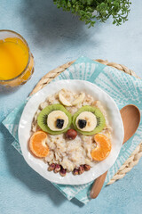 Wall Mural - Kids breakfast porridge with fruits and nuts