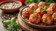 Close-up of savory meatballs in rich tomato sauce garnished with herbs on rustic kitchen table. Homemade juicy meatballs in tomato sauce with fresh herbs