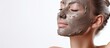 Radiant Woman Enjoying a Rejuvenating Clay Mask Treatment for Skin Health and Beauty