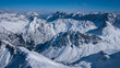 Winter mountain panorama from mountain peak of Namloser Wetterspitze in Tyrol, Austria, sunny blue sky day.