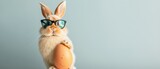 Fototapeta Las - Happy easter concept holiday animal greeting card - Cool Easter bunny with sunglasses leans on a large easter egg, isolated on aquamarine background