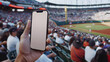 © BeautyStock - Man fan hands holding isolated smartphone device in baseball crowed stadium game with blank empty white screen, sports betting concept