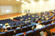 © narin_nonthamand - blurred or defocused people in the seminar convention hall. Business meeting for a press conference or lecturer education concept with a wide view from the room's corner. Modern, blurry auditorium.