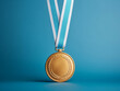 © Johannes - Gold medal on blue ribbon isolated on white blue background, winning theme.