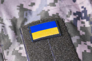 Wall Mural - Close up khaki camouflage amunition. Armed Forces of Ukraine. Ukrainian army. Ukrainian flag on military uniform.