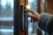 Embracing Modern Security A Close-Up of a Woman’s Finger Skillfully Entering a Password on a Smart Digital Touch Screen Keypad Door Lock