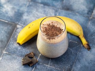 Wall Mural - Banana smoothie with chocolate, sweet milk dessert.