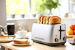 A sleek modern toaster with freshly toasted bread on a sunny bright kitchen countertop table with hot coffee and citrus fruits. Concept of a healthy and energizing morning breakfast routine
