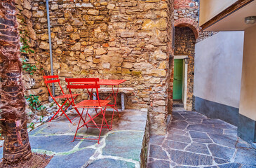 Wall Mural - The outdoor table with chairs on the street of Gandria, Switzerland