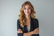 © hasara - Confident Businesswoman, Smiling, Professional Portrait, Blonde Hair, Arms Crossed, Business Attire, Neutral Background