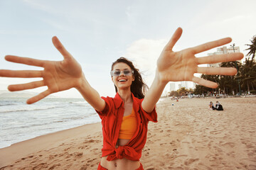 Wall Mural - Smiling Woman's Joyful Embrace of Freedom and Beauty by the Colorful Sea