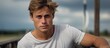 © HN Works - Intense Young Man in White Shirt Captivated by Gaze Outdoors