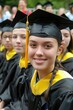 © AdriFerrer - Close-up of a young graduate in black and yellow regalia.