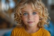 A close-up portrait of a charming boy with blue eyes and curly hair