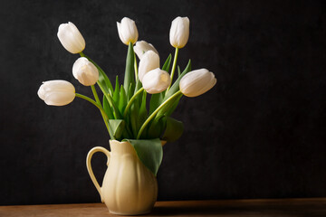 Wall Mural - A bouquet of white tulips in a yellow jug