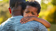 Young African American Boy Hugging and Embracing Father with Sad Face and Expression: Exploring Divorce and Childhood Trauma Themes
