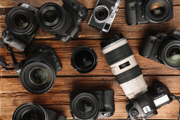 Wall Mural - modern cameras on wooden table, flat lay