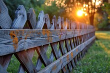 A Warm Sunset Casts Golden Light On An Old Wooden Fence Covered With Lichen, Symbolizing Time And Nature