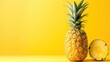 a pineapple cut in half sitting next to a half of a pineapple on a yellow and yellow background.