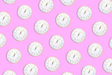 Fototapeta Lawenda - Pattern made with clock dials with golden details on bright pink background.
Creative minimal art. Flat lay. Copy space. Minimal composition.