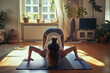 A girl doing yoga on a mat in the living room